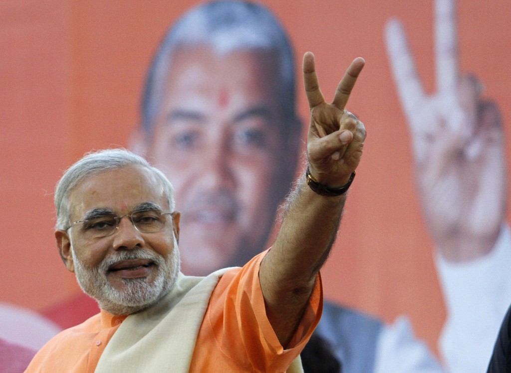 Narendra Modi, chief minister of Gujarat state, gestures on the podium during a felicitation ceremony in Ahmedabad